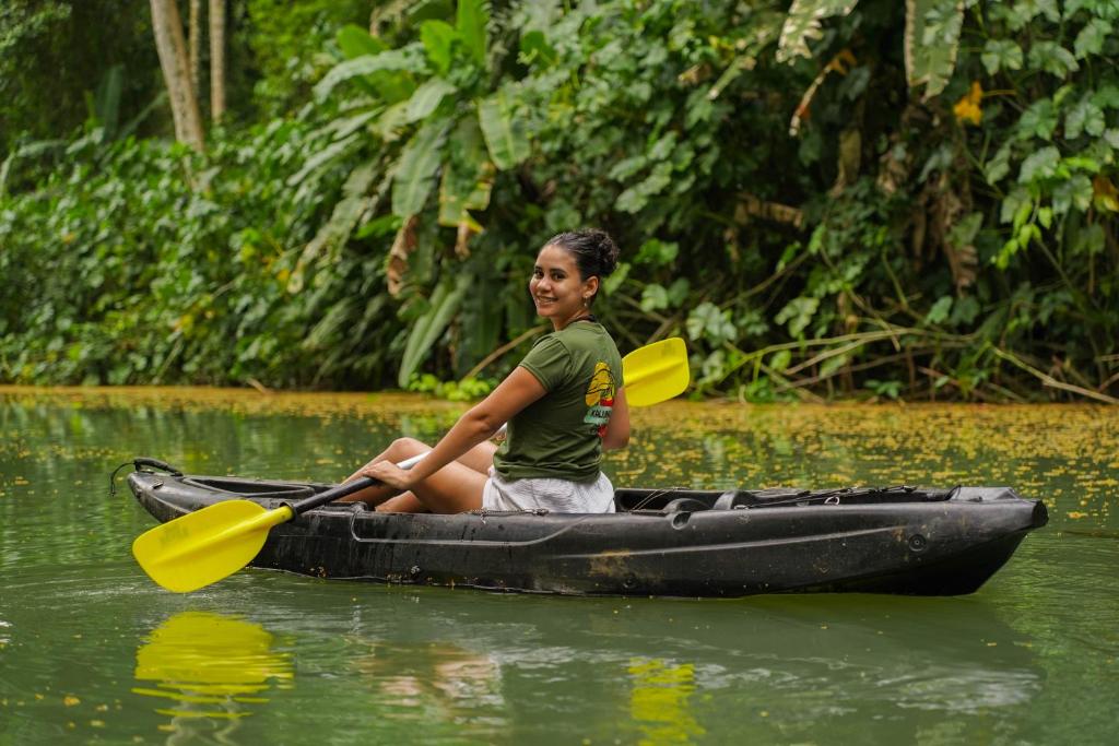 a young girl sitting in a kayak in the water at Kalunay Hostel - Breakfast included in Puerto Viejo