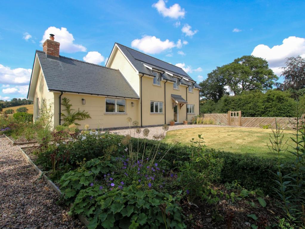 a house with a garden in front of it at Hoddell Pitch Cottage in Presteigne