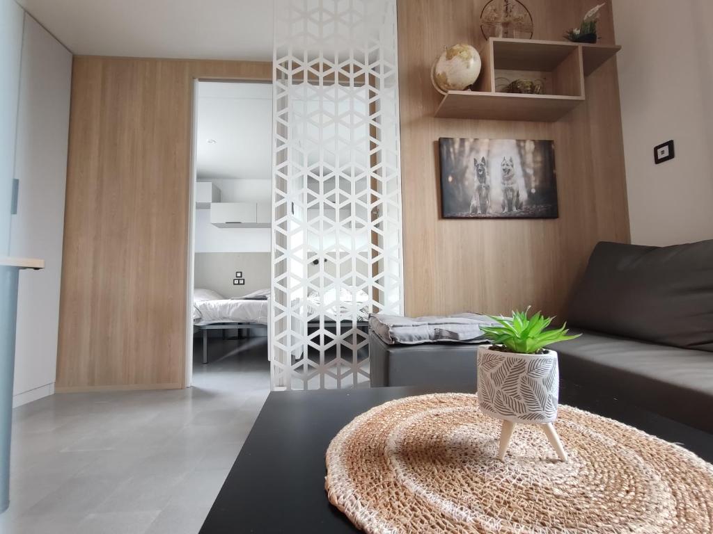 a living room with a couch and a table at Mobile home à Mimizan géré par un particulier in Mimizan
