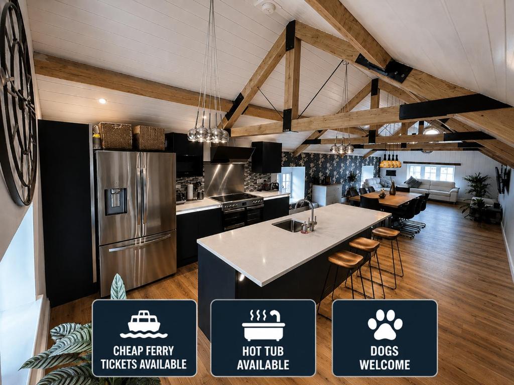 a kitchen with a refrigerator and a table with stools at Colemans Retreat in Porchfield