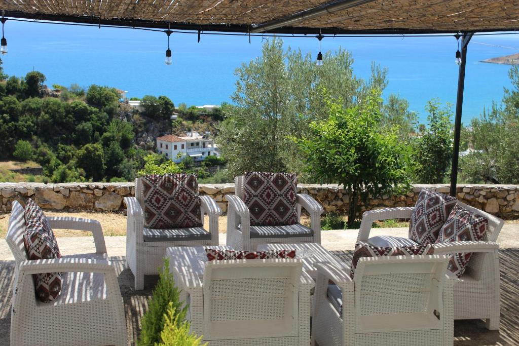 a group of chairs sitting on a patio at Vila Sosana in Qeparo