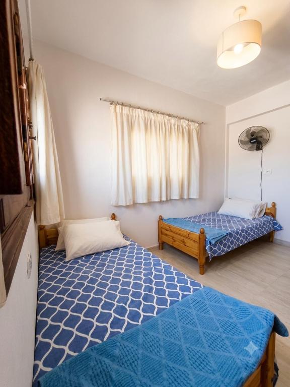 a bedroom with two beds and a window at Zaytouna camp Room 2 in Marsa Matruh
