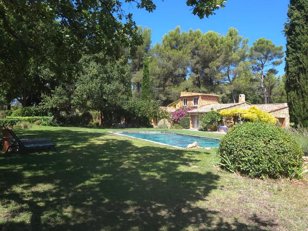 a swimming pool in the yard of a house at Le mas des escans in Le Beausset