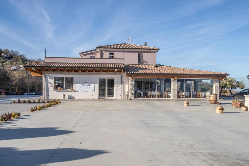 a large white building with a roof at Tenuta Giave - nel cuore dell'Irpinia in Montemarano