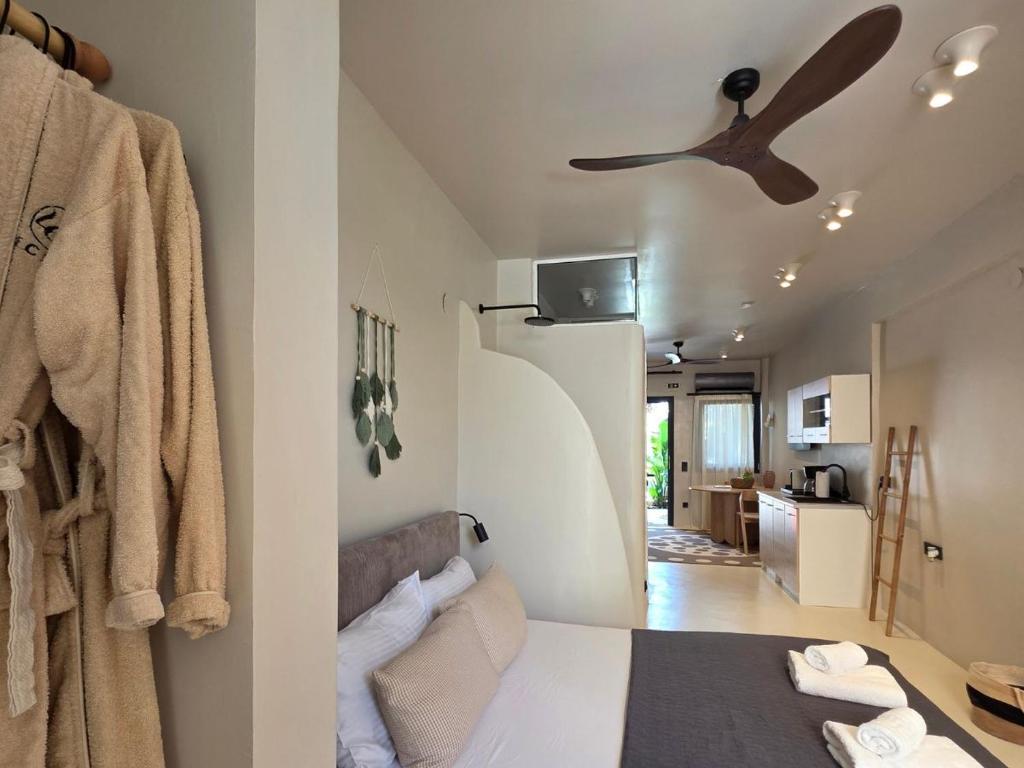a bedroom with a bed and a ceiling fan at Vaios Luxury Apartments in Polychrono