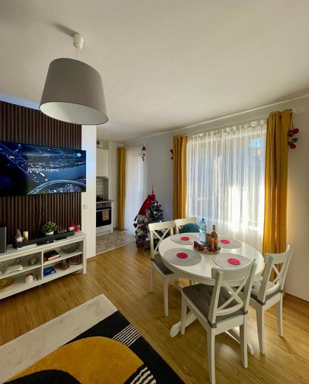 a living room with a white table and chairs at Hrebet House Borovets in Borovets