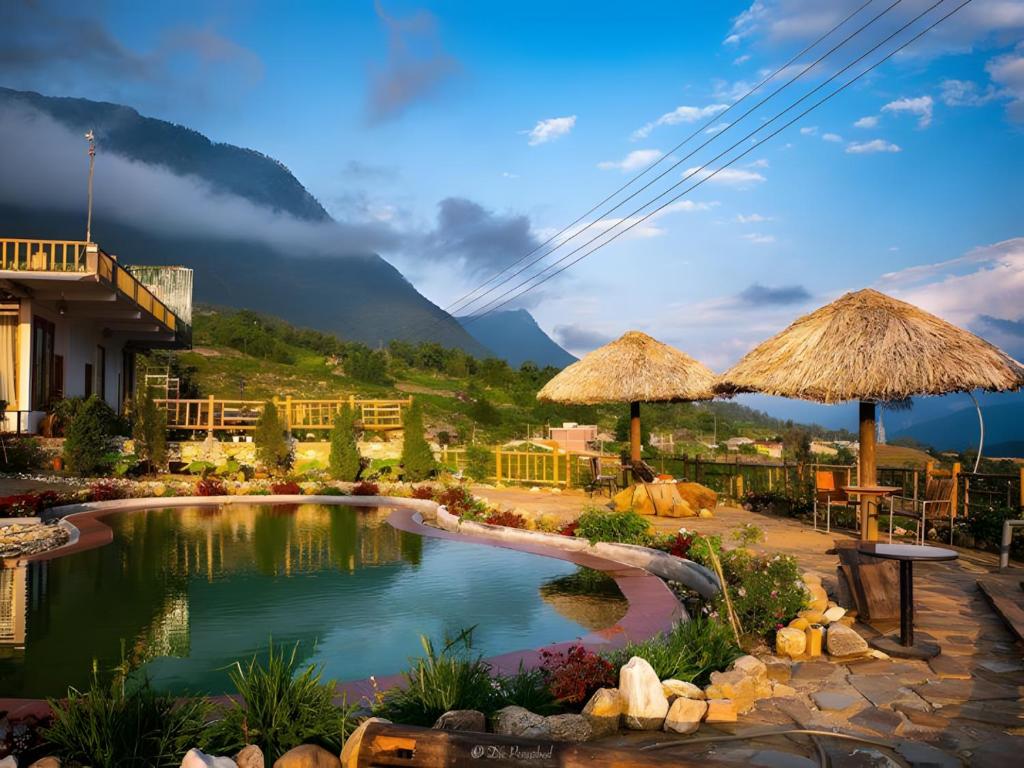 a pool at a resort with mountains in the background at D&D Eco Sapa in Sapa