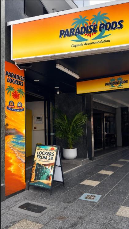 a store with a sign in front of a building at Paradise Pods in Gold Coast