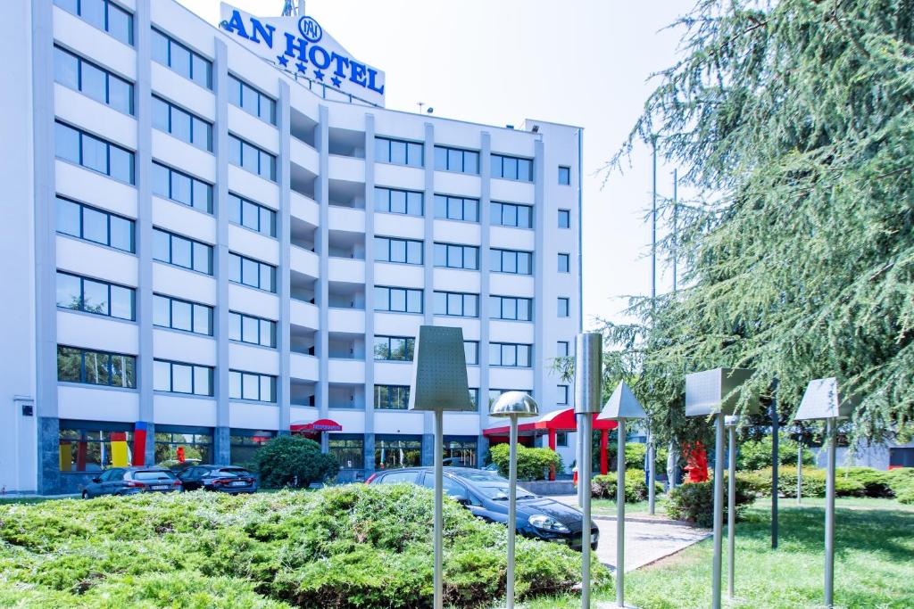 a hotel building with cars parked in front of it at AN Hotel Milano San Donato in San Donato Milanese