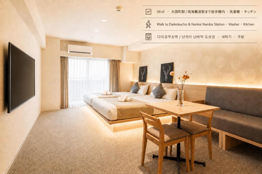 a bedroom with a bed and a table and a couch at Apartment Hotel 11 Namba in Osaka