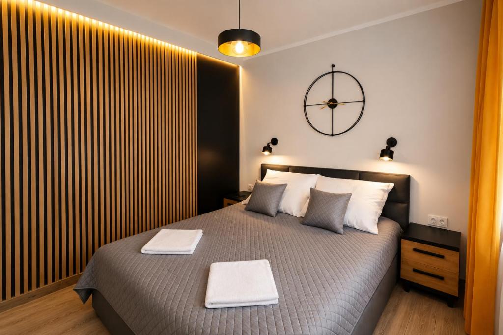a bedroom with a large bed with two tables on it at Ewilla- apartamenty Wojcieszyce in Wojcieszyce