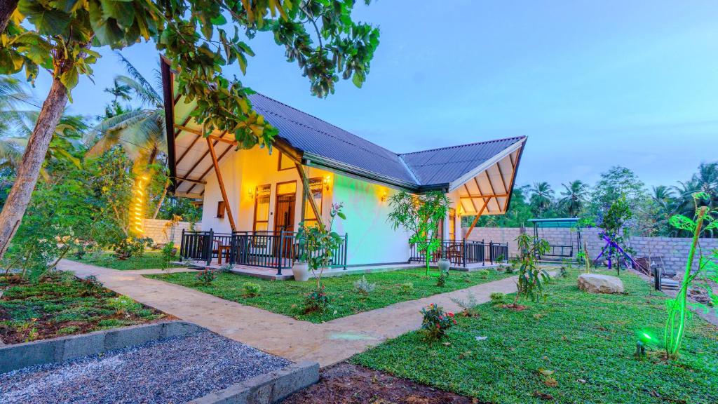 a small house with a pitched roof at Akash Treehouse in Sigiriya
