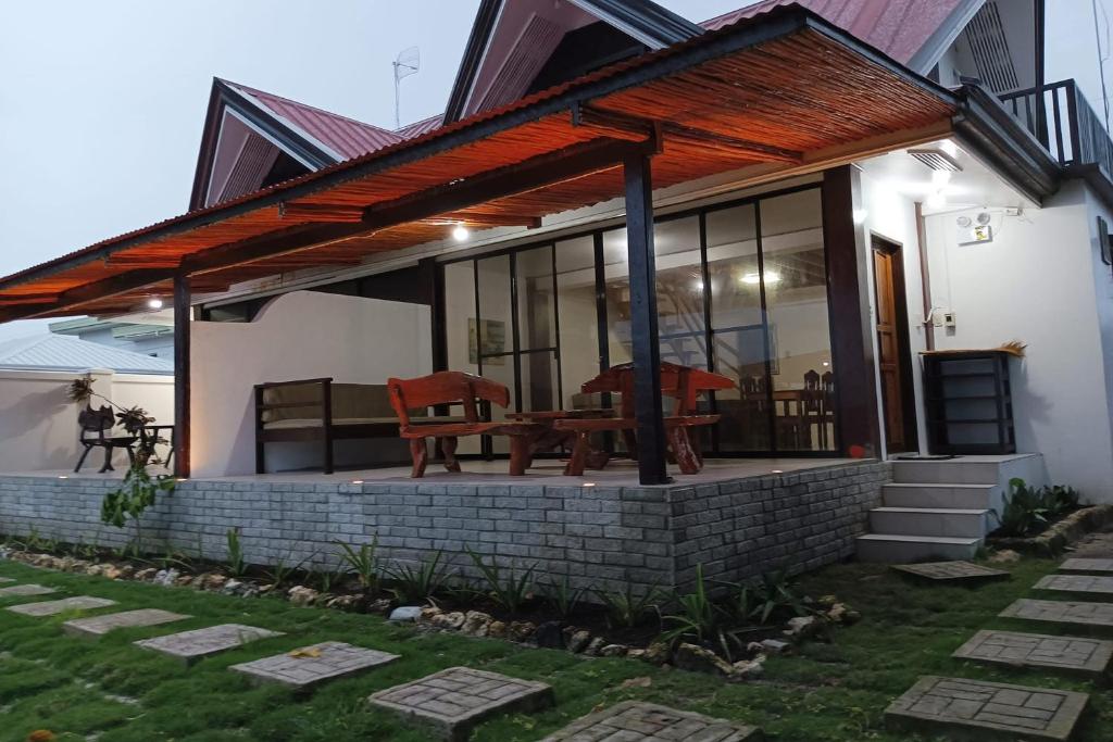 a small house with a patio with a table at Angelito's Beach House Siargao near Beach in General Luna