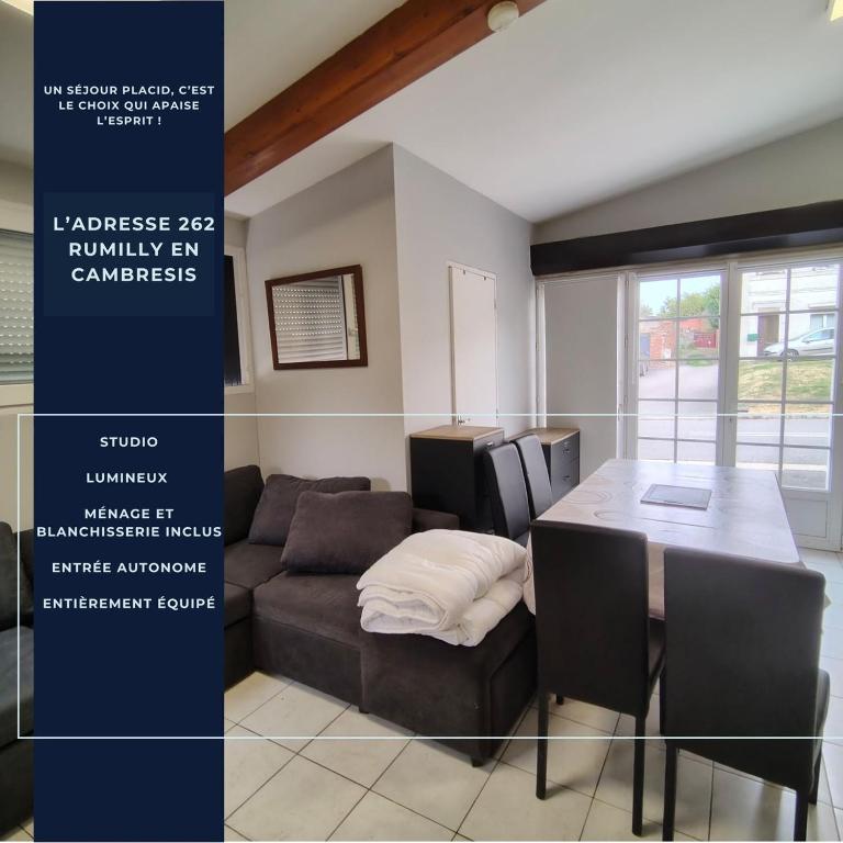a living room with a couch and a table at L’Adresse 262 