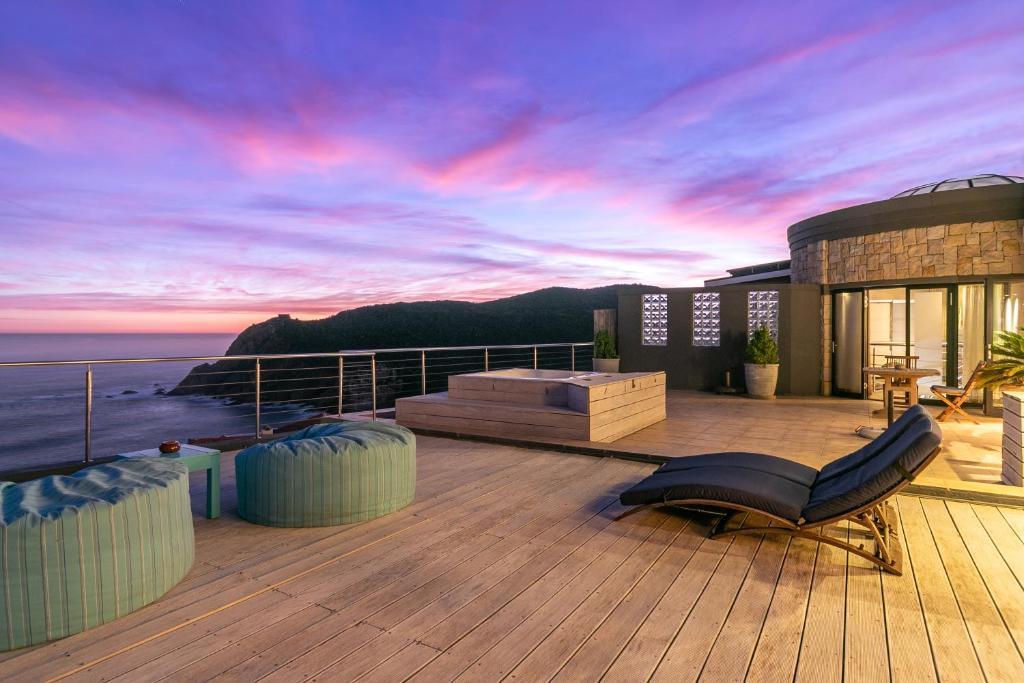 a balcony of a house with a view of the ocean at Alexander Guest House in Knysna