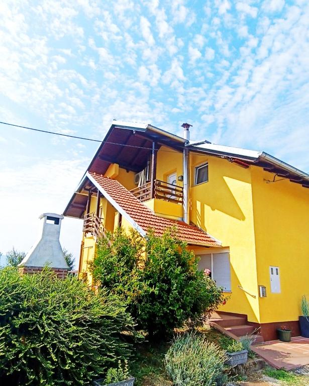 a yellow building with a sky in the background at Apartment Petra Zabok Horizon Suite in Zabok
