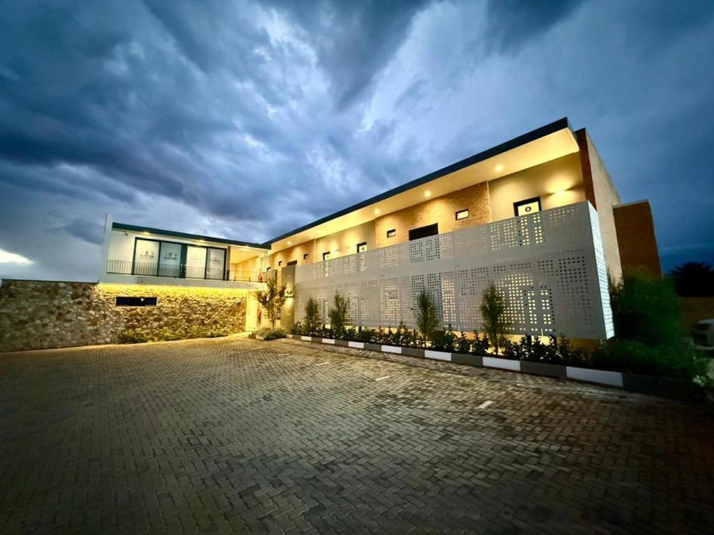 a building with a brick driveway in front of it at The Circle Luxury Self Catering Studios in Potchefstroom
