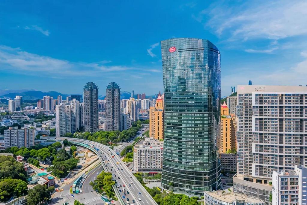 a view of a city with a tall skyscraper at Shenzhen O Hotel in Shenzhen