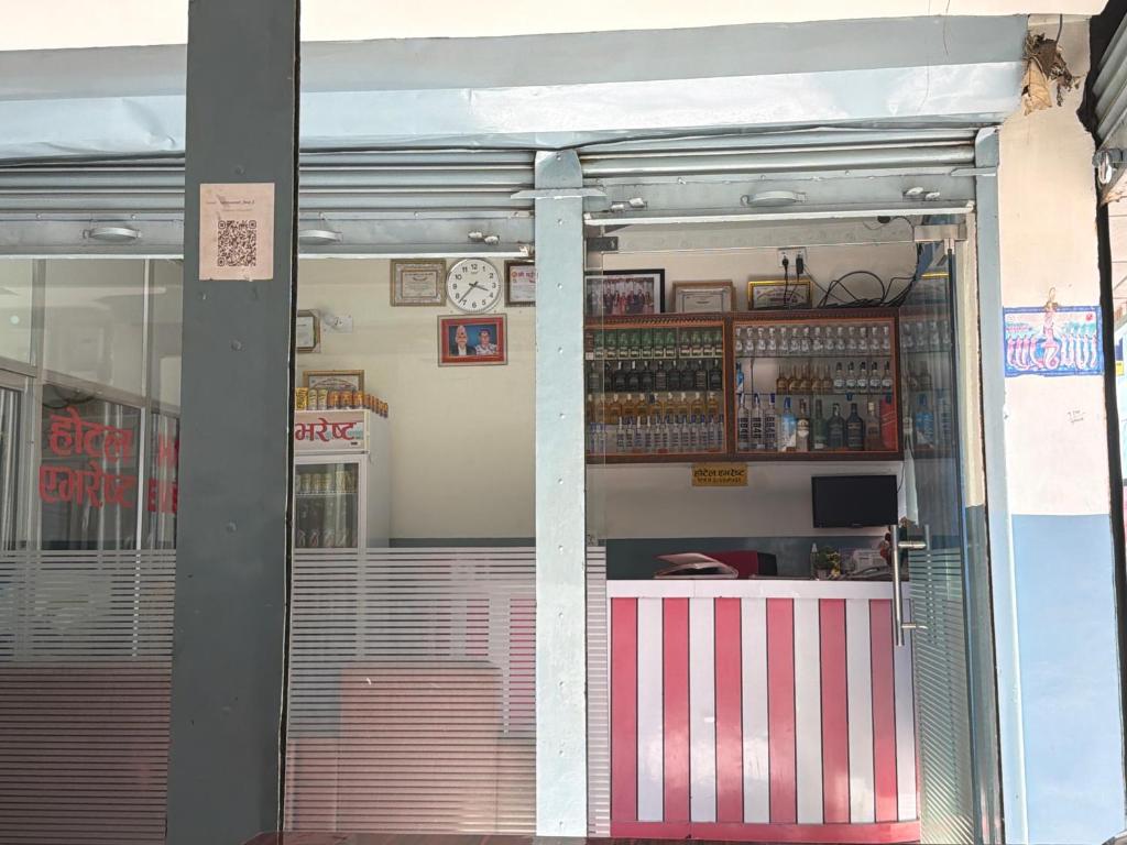 a store front with a clock on the wall at Hotel Everest in Butwāl