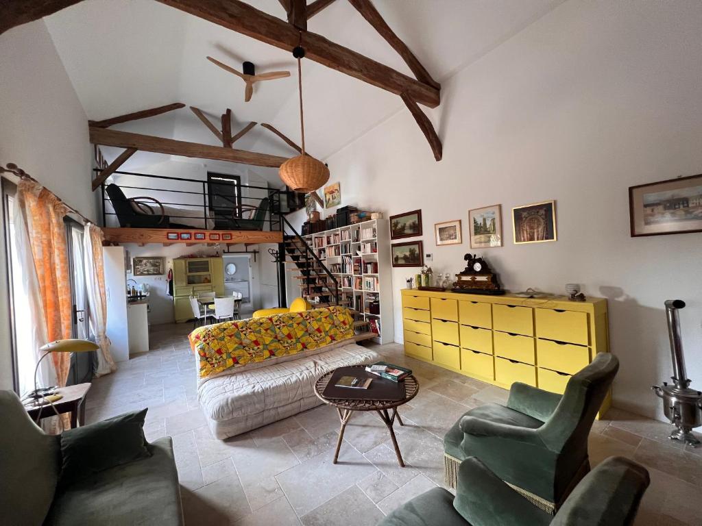 a living room with a couch and chairs at Le CRAMPOT in Lectoure