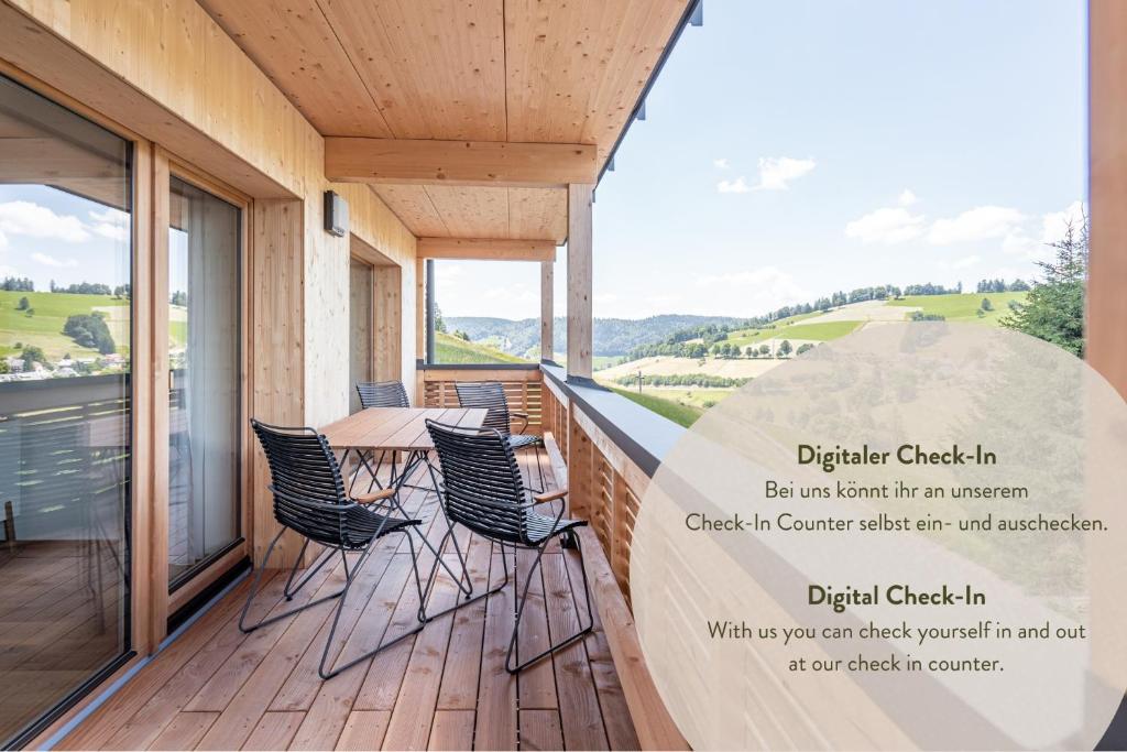 a balcony with chairs and a table with a view at stuub todtnauberg in Todtnauberg