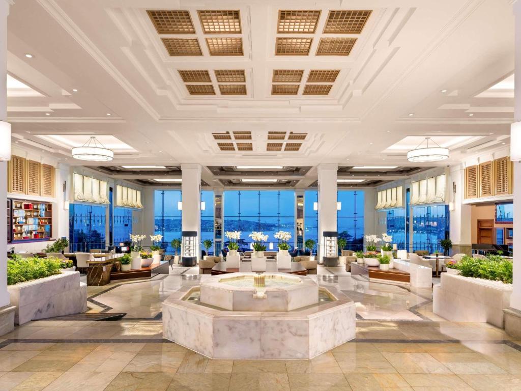 a lobby of a hotel with tables and chairs at Swissotel The Bosphorus Istanbul in Istanbul