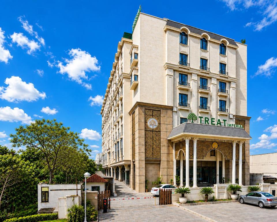 a hotel building with a car parked in front of it at Treat Imperial Aurangabad City Center in Aurangabad
