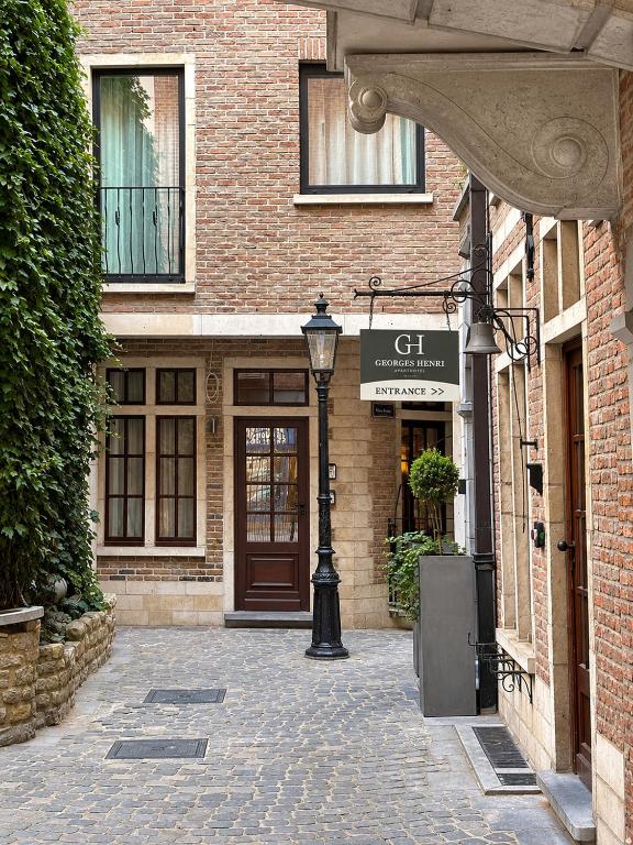 a brick building with a street light in front of it at Georges Henri Aparthotel in Brussels