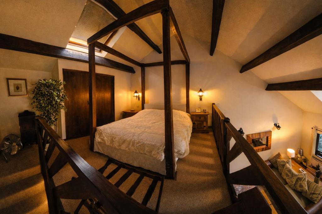 a bedroom with a canopy bed in a room at Langford Apartment and Rooms in Bristol