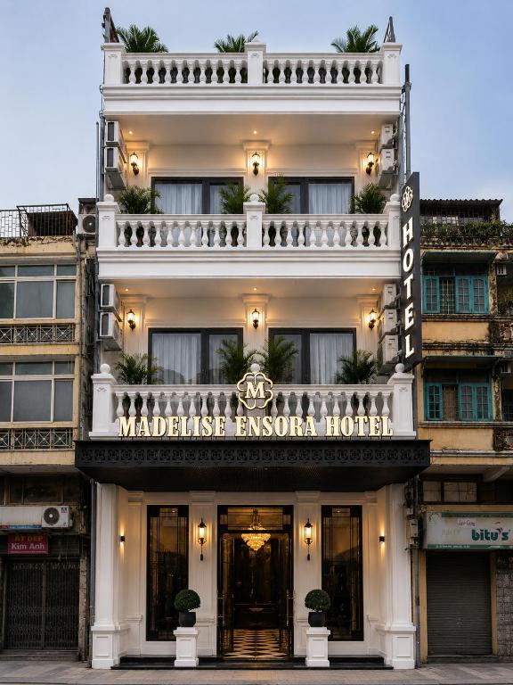 a building with a sign for the waldridge esquire hotel at Madelise Ensora Hotel & Travel in Hanoi