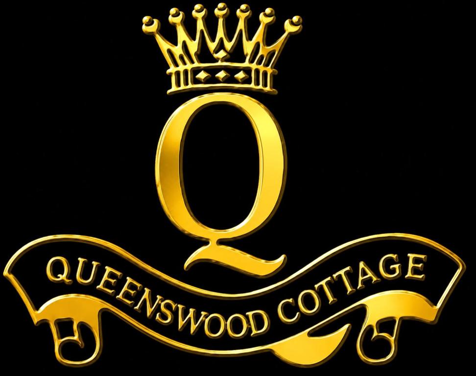 a gold sign with a crown on top at Queenswood Cottage in Nuwara Eliya