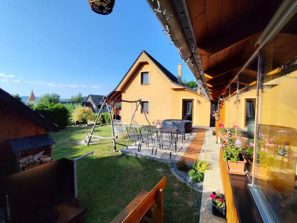 a house with a yard with a swing at Chata Monika Veľké Pole in Veľké Pole