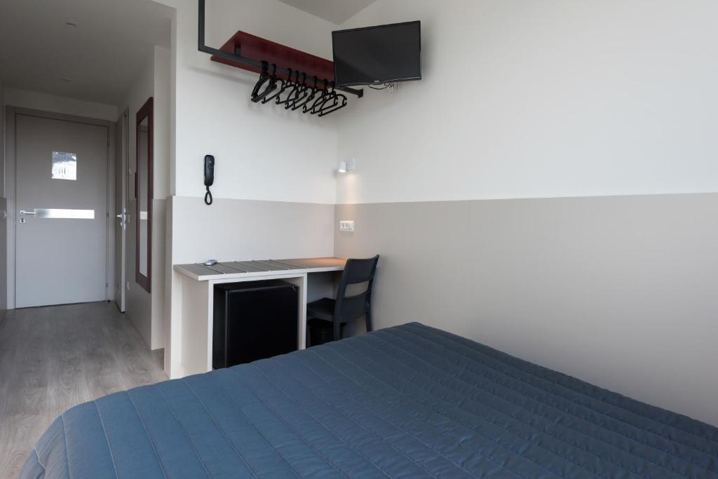 Voodi või voodid majutusasutuse Hotel Porta Palio toas