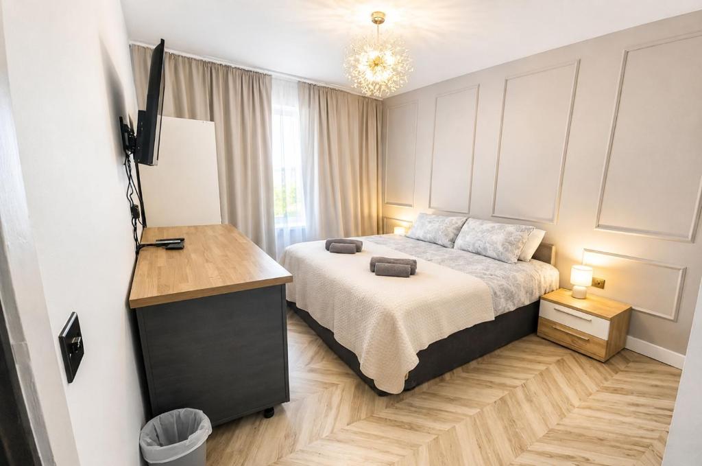 a bedroom with a bed and a television in it at Stylish 2BR House Parking & WiFi Sleeps 6 in Grangemouth