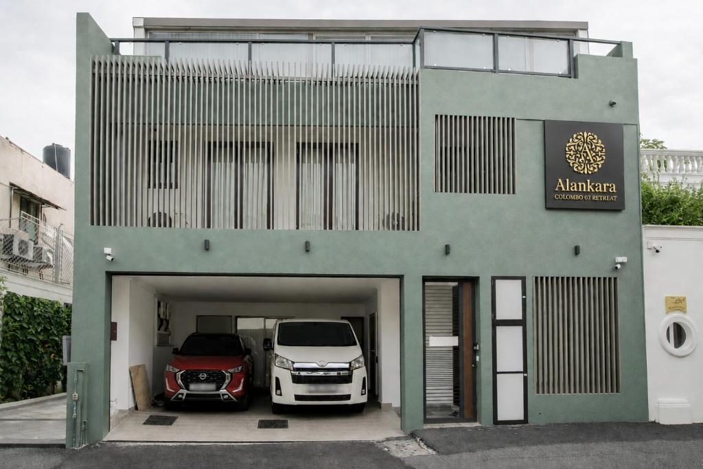 a building with two cars parked in a garage at Alankara Retreats Colombo 07 in Colombo