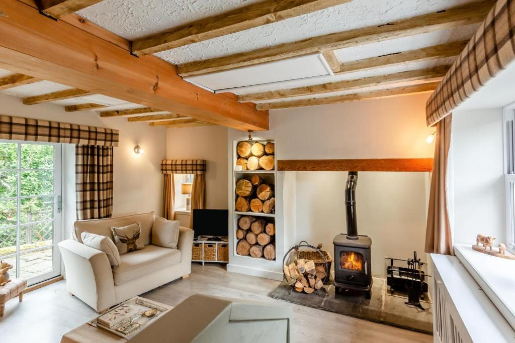 a living room with a couch and a wood stove at 1 Bed in Callander oc-pe173 in Strathyre