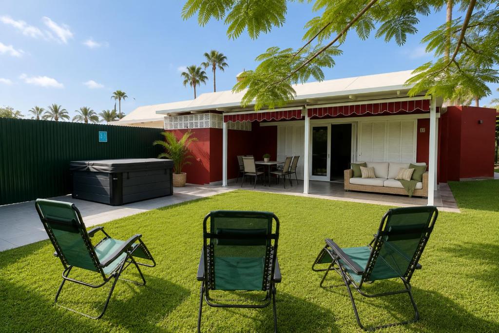 two chairs and a grill in the yard of a house at Albaricoques Sun & Beach in Maspalomas