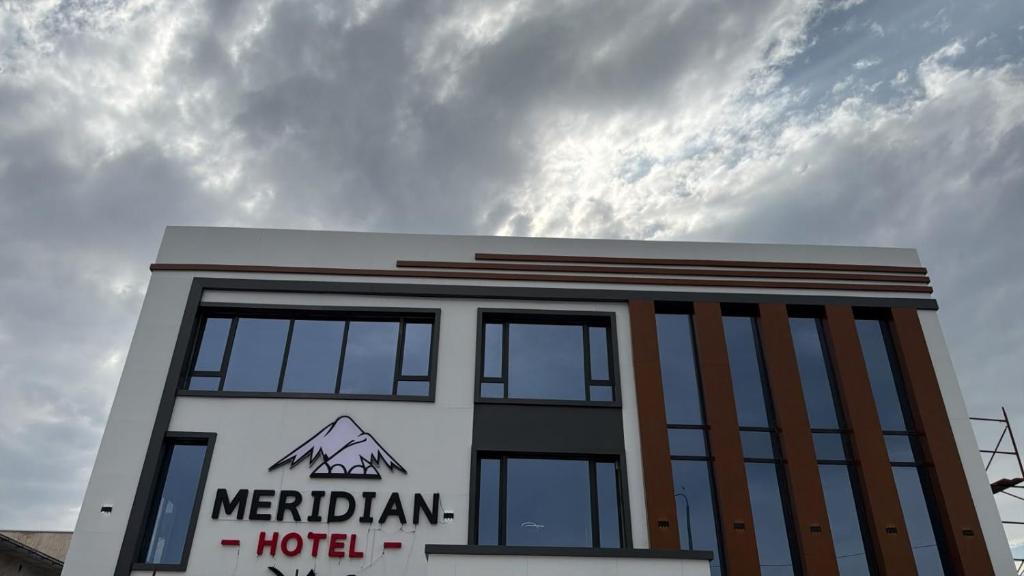 a hotel building with the sky in the background at Meridian Hotel in Georgīevka