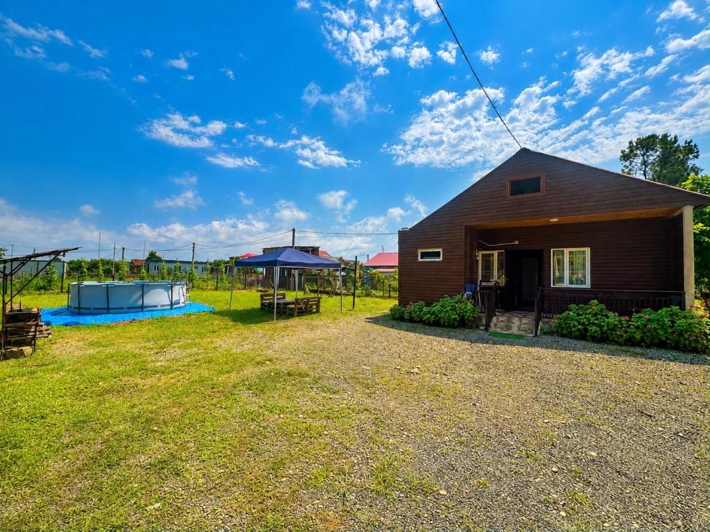 a home with a yard with a house at Luna di Mare in Ureki