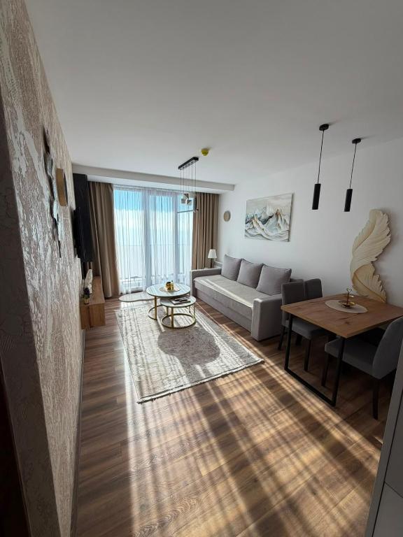 a living room with a couch and a table at Gold Elegant & Spa Kop in Kopaonik