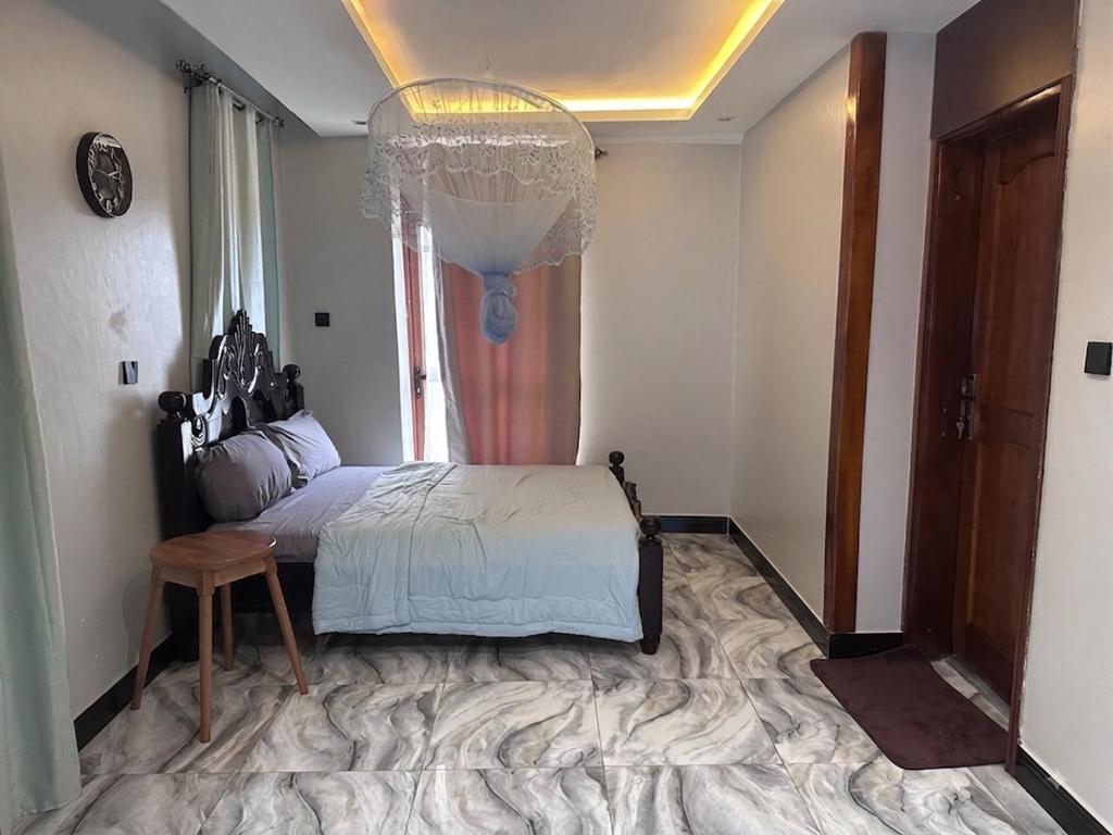 a bedroom with a bed and a large window at Rift Valley in Bulenga