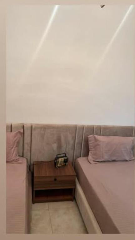 a bed with a side table with a camera on it at La perle de bizerte in Bizerte