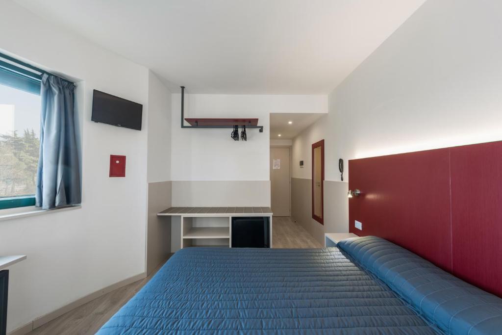 Voodi või voodid majutusasutuse Hotel Porta Palio toas