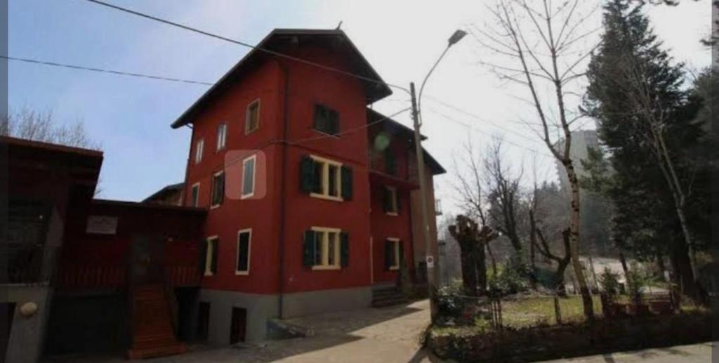 a red house with a black roof at Locanda San Nicolo - Sestola Centro in Sestola