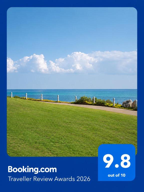 a flyer for a travel review awards with a view of the ocean at Beach house بيت البحر in As Sīfah