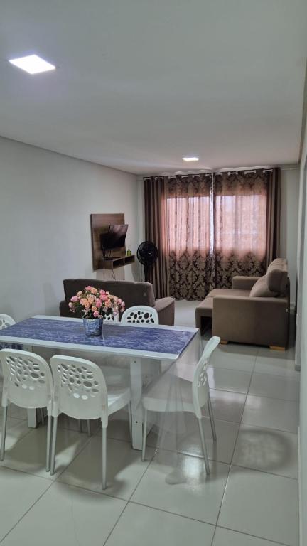 a living room with a table and chairs and a couch at Apartamento Maragogi Peroba in Maragogi