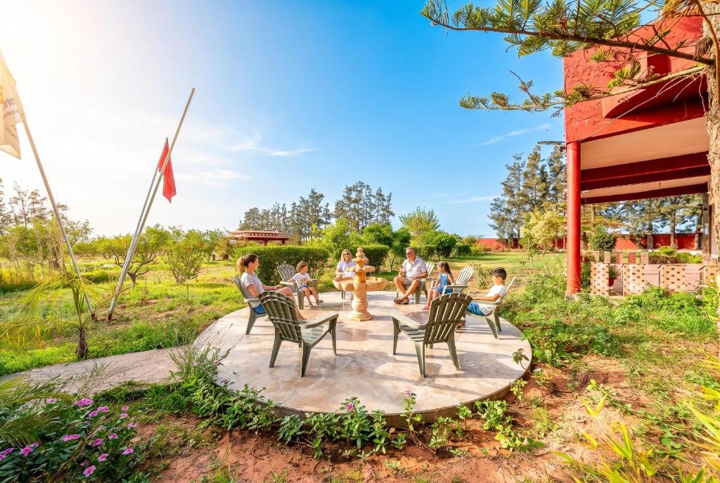 a group of people sitting in chairs on a patio at Paradise Farm 20 min from Rabat By MasterHost with AC in Salé