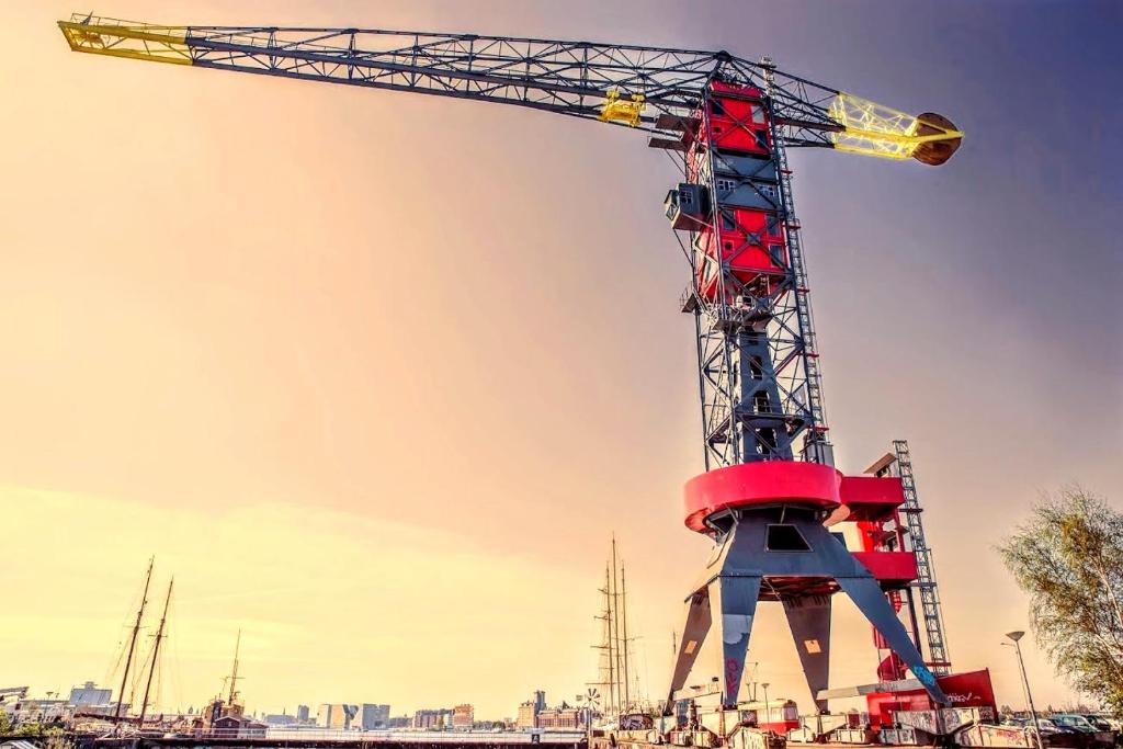a large crane in front of a city at Faralda Crane Hotel in Amsterdam