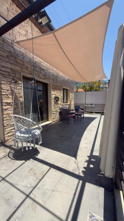 a patio with a hammock and a building at Amarillis lb 