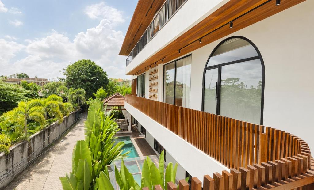 an external view of a house with a balcony with a swimming pool at 4Bedroom Umah Jeng Alessia Villa - Pererenan by SooBali in Munggu